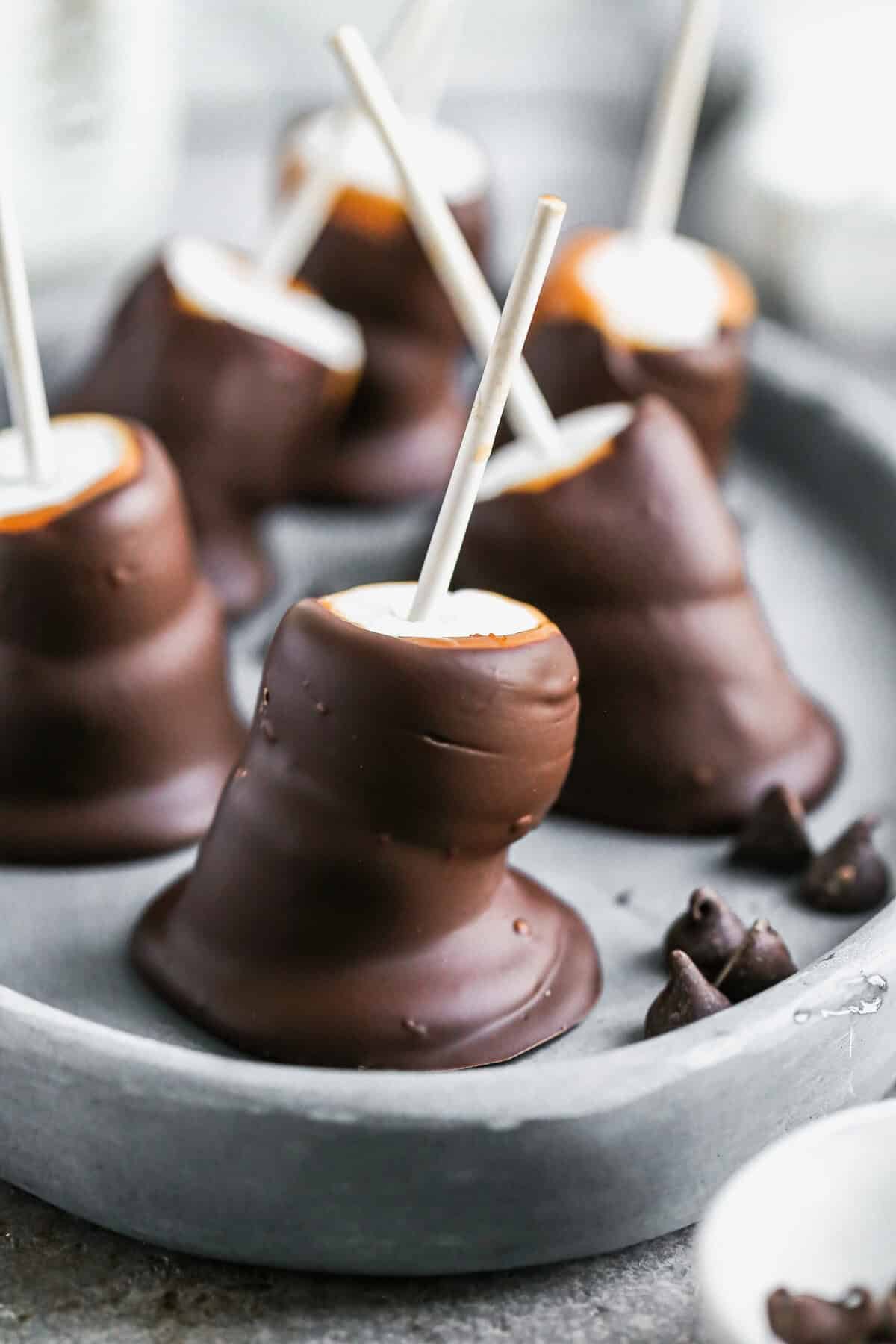 Chocolate-covered marshmallows are an easy, no-bake treat kids can dip and decorate with holiday toppings.