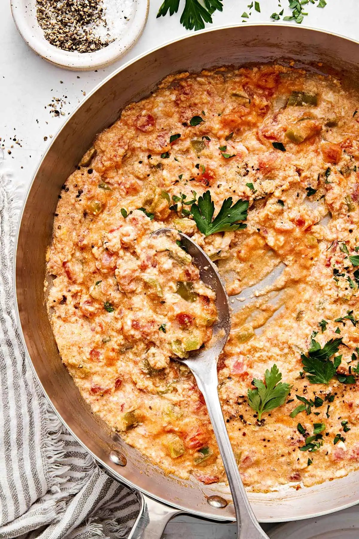 Turkish menemen in a pan with parsley.