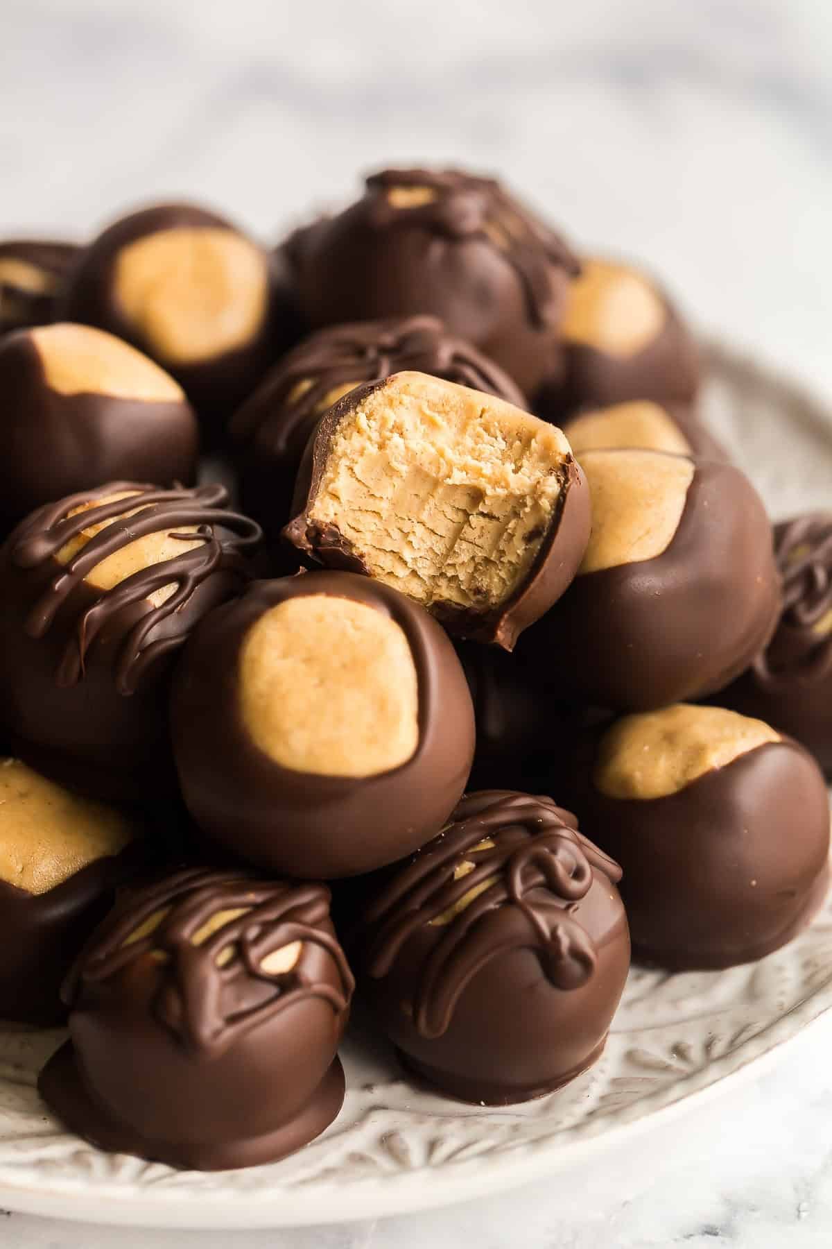 Une bille de beurre de cacahuète au chocolat mordue à côté de billes intactes.
